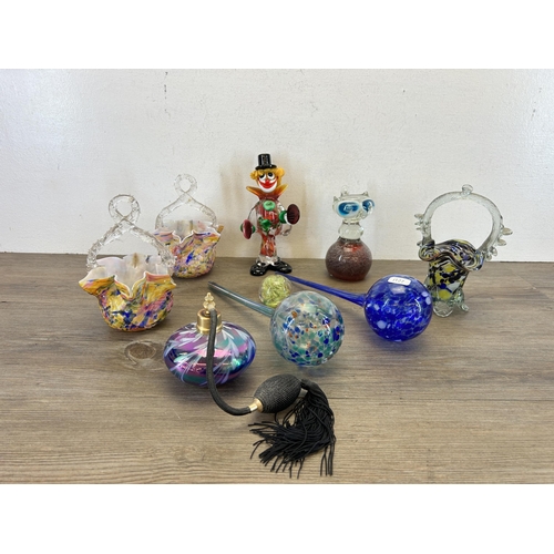 387 - A collection of art glassware to include Murano clown, atomiser, Isle Of Wight paperweight etc.