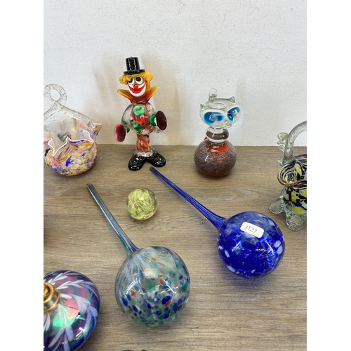 387 - A collection of art glassware to include Murano clown, atomiser, Isle Of Wight paperweight etc.