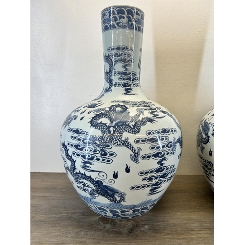 402 - A pair of Chinese blue and white porcelain dragon pattern bottle neck floor vases with Qianlong six ... 