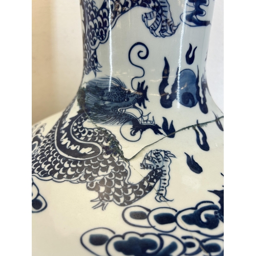 402 - A pair of Chinese blue and white porcelain dragon pattern bottle neck floor vases with Qianlong six ... 