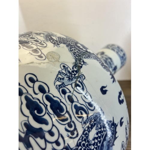 402 - A pair of Chinese blue and white porcelain dragon pattern bottle neck floor vases with Qianlong six ... 