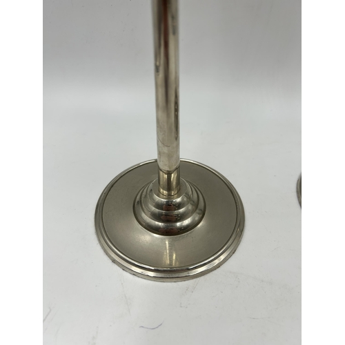 422 - A pair of Art Deco style chrome plated candle sticks - approx. 32cm high