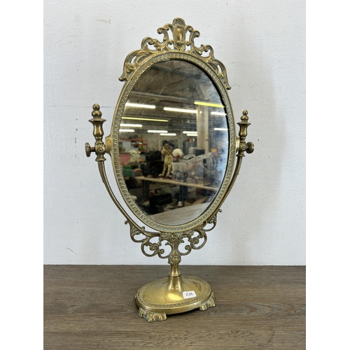 427 - A Rococo style brass framed oval swing mirror - approx. 49cm high x 30cm wide