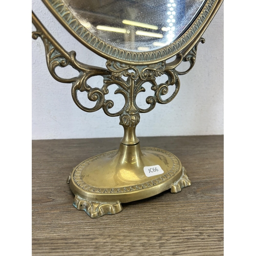 427 - A Rococo style brass framed oval swing mirror - approx. 49cm high x 30cm wide