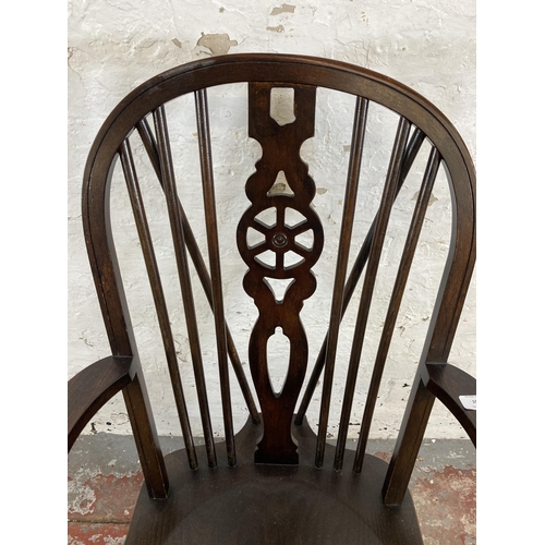 107 - A 19th century style elm and beech wheelback armchair
