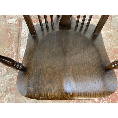 107 - A 19th century style elm and beech wheelback armchair