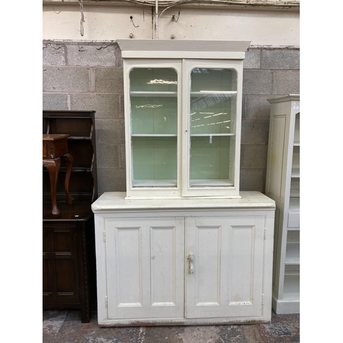11 - Two pieces of Victorian white painted furniture, one glazed bookcase top and one housekeeper’s cupbo... 