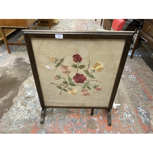111 - Two pieces of furniture, one mid 20th century oak framed floral embroidered fire screen and one Vict... 