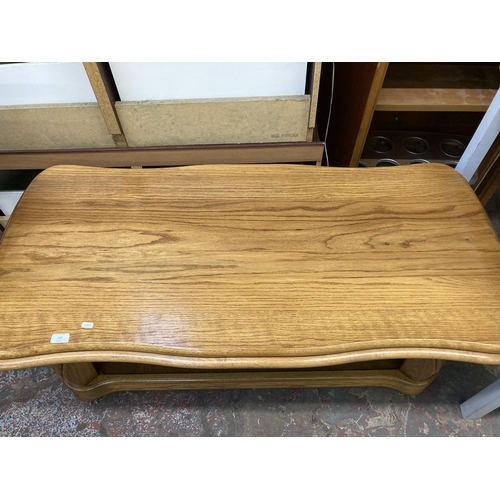 123 - An oak serpentine two tier coffee table