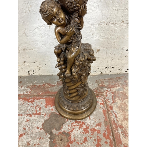 124 - A bronzed cast metal jardinière stand with cherub and grape design - approx. 90cm high x 29cm wide x... 
