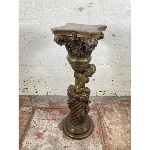 124 - A bronzed cast metal jardinière stand with cherub and grape design - approx. 90cm high x 29cm wide x... 