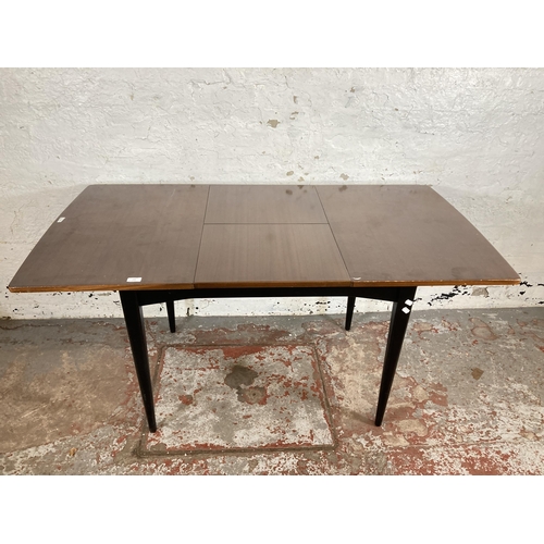 133 - A mid 20th century Wrighton tola wood and ebonised extending dining table and four chairs  - approx.... 