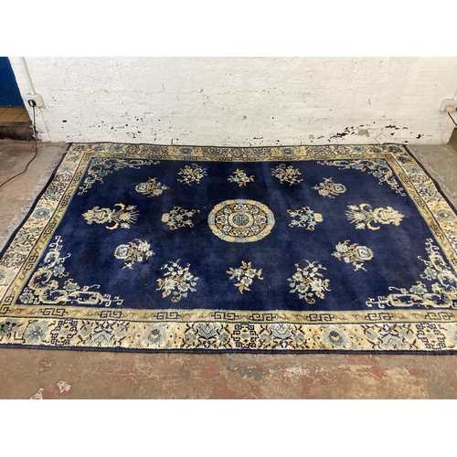 136 - A Lahore Carpet Co. Pakistani blue floral pattern rug - approx. 280cm x 190cm