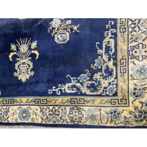 136 - A Lahore Carpet Co. Pakistani blue floral pattern rug - approx. 280cm x 190cm