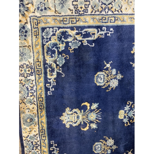 136 - A Lahore Carpet Co. Pakistani blue floral pattern rug - approx. 280cm x 190cm