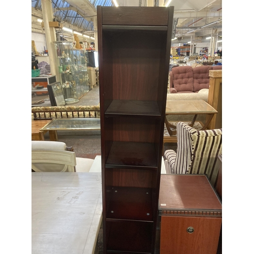 140 - Three pieces of furniture, one mahogany two tier open bookcase, one mahogany effect revolving CD cab... 