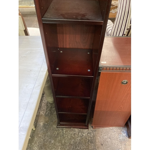 140 - Three pieces of furniture, one mahogany two tier open bookcase, one mahogany effect revolving CD cab... 