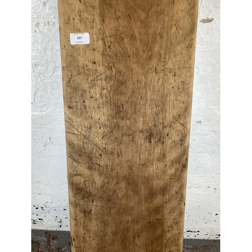 157 - A rustic wooden shelf with cast metal brackets - approx. 227cm long x 27cm deep