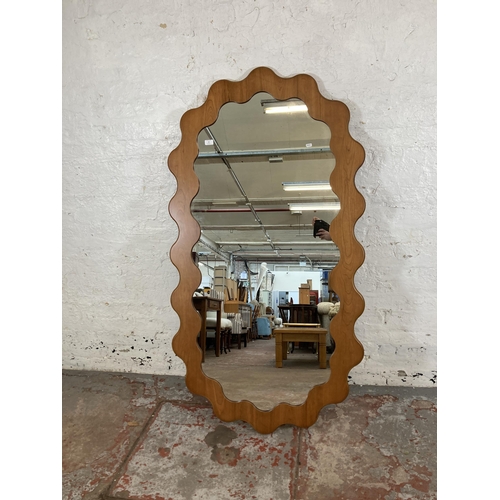 16 - An Urban Outfitters Sofia cherry wood framed wall mirror - approx. 165cm high x 89cm wide