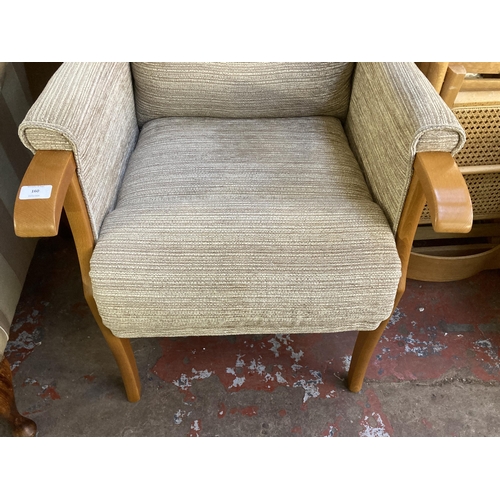 160 - A modern beech and fabric upholstered wingback armchair