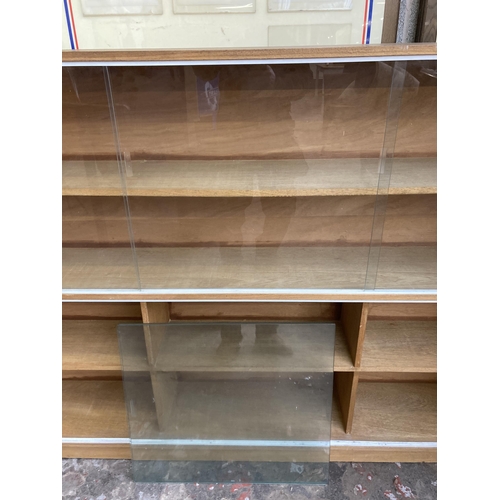 2 - A mid 20th century teak four tier bookcase with six glass sliding doors - approx. 122cm high x 183cm... 