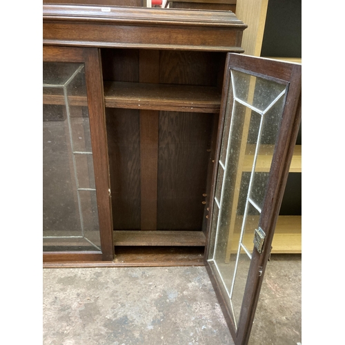 23 - An early 20th century oak bookcase top with two lead glazed doors