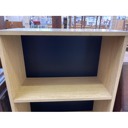 24 - A modern oak effect three tier open bookcase - approx. 122cm high x 63cm wide x 30cm deep