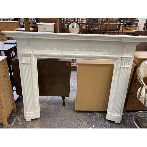 29 - A Victorian style white painted wooden fire surround - approx. 130cm high x 168cm wide x 20cm deep