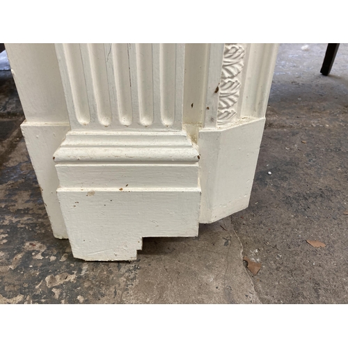 29 - A Victorian style white painted wooden fire surround - approx. 130cm high x 168cm wide x 20cm deep