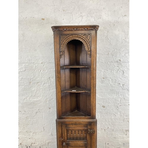 39 - A Titchmarsh & Goodwin style carved oak free standing corner cabinet - approx. 167cm high