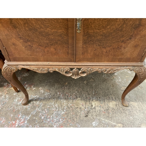 41 - A walnut cocktail cabinet on cabriole supports - approx. 98cm high x 89cm wide x 44cm deep