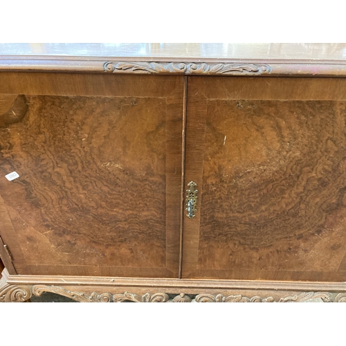 41 - A walnut cocktail cabinet on cabriole supports - approx. 98cm high x 89cm wide x 44cm deep