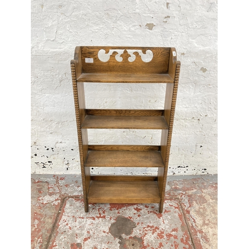 52 - An early 20th century carved and beaded oak four tier bookcase - approx. 92cm high x 46cm wide x 16c... 