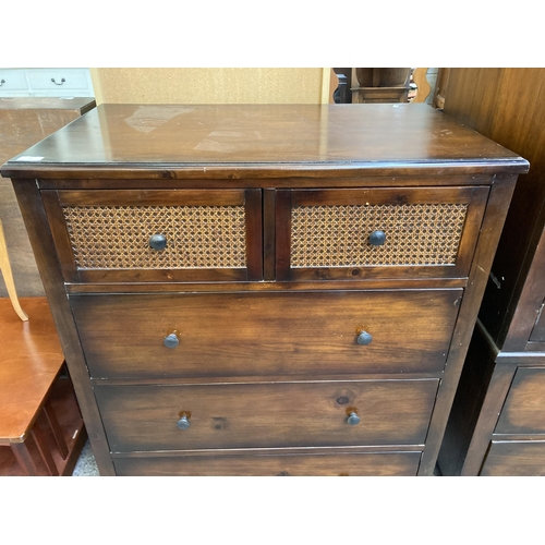 57 - A modern pine effect and rattan chest of drawers - approx. 105cm high x 88cm wide x 53cm deep