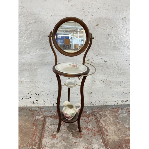 70 - A Georgian style mahogany wash stand and mirror with ceramic water jug and bowl - approx. 132cm high