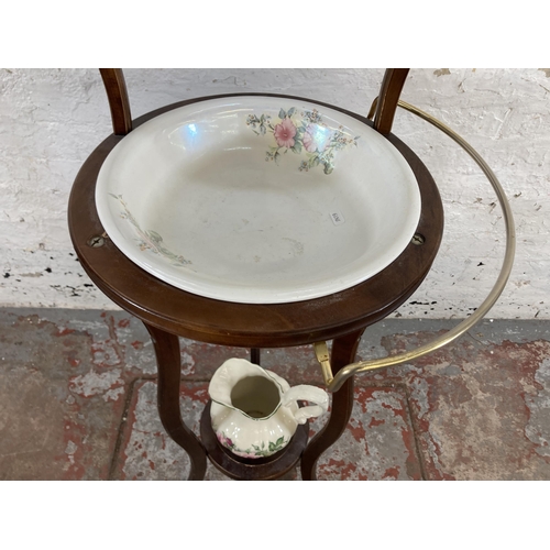 70 - A Georgian style mahogany wash stand and mirror with ceramic water jug and bowl - approx. 132cm high