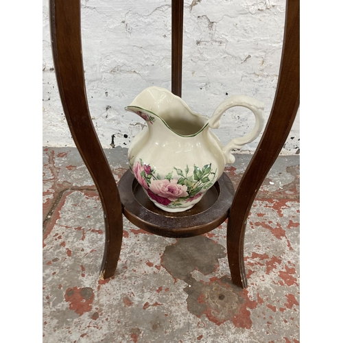 70 - A Georgian style mahogany wash stand and mirror with ceramic water jug and bowl - approx. 132cm high