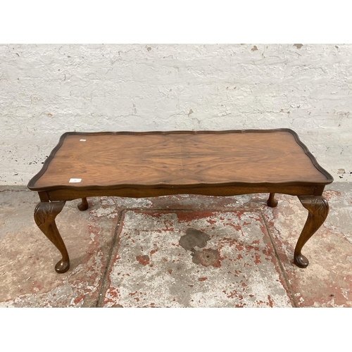 73 - A walnut serpentine rectangular coffee table on cabriole supports