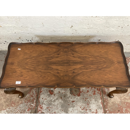 73 - A walnut serpentine rectangular coffee table on cabriole supports