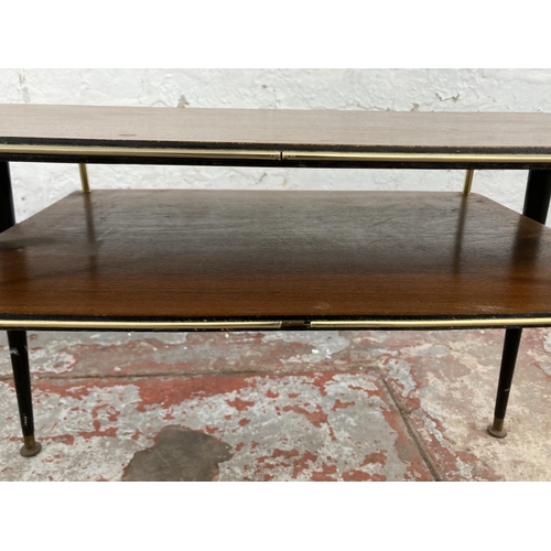 74 - A mid 20th century teak and ebonised two tier coffee table
