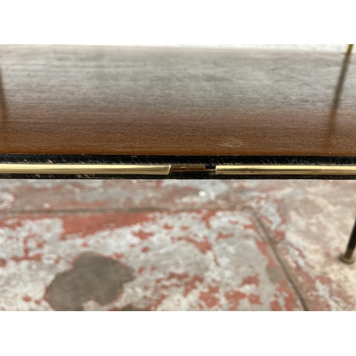 74 - A mid 20th century teak and ebonised two tier coffee table