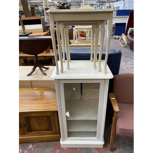 79 - Two pieces of modern white painted furniture, one nest of table and one stereo cabinet