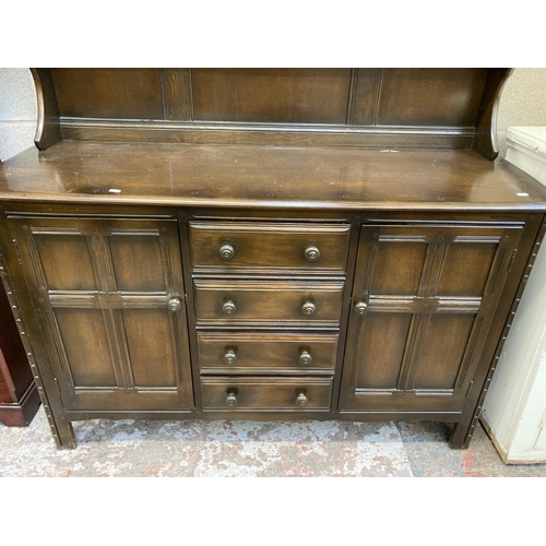 8 - A mid 20th century Ercol Old Colonial dark elm dresser - approx. 170cm high x 145cm wide x 50cm deep