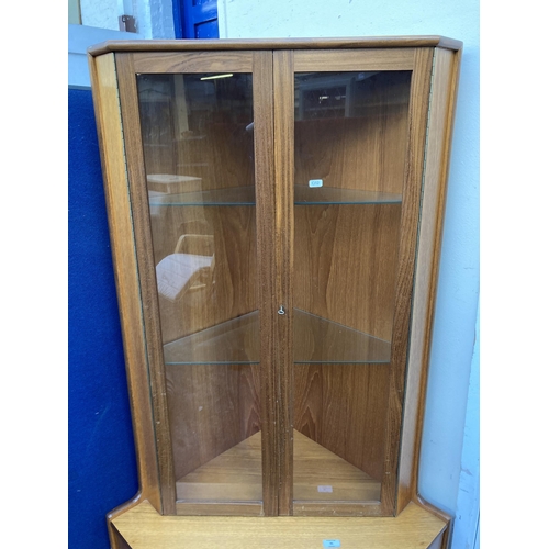91 - A mid 20th century teak free standing corner cabinet - approx. 170cm high