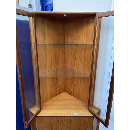 91 - A mid 20th century teak free standing corner cabinet - approx. 170cm high
