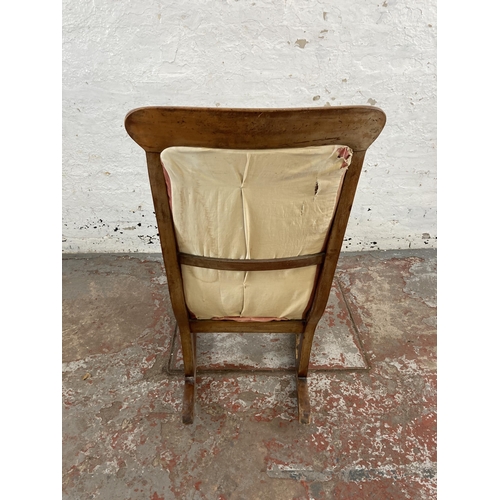 98 - A 19th century beech and fabric upholstered rocking chair