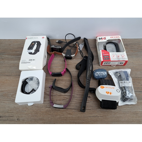 743 - A box containing various fitness trackers and wearables to include Huawei Band 4, Fitbit Alta, Timex... 