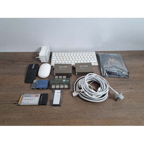 765 - A box containing computing items and accessories to include Apple mouse and keyboard, Apple plug and... 