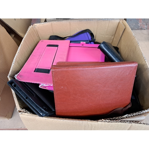 767 - Two boxes, one containing tablet cases and one containing technology items and damaged tablets to in... 