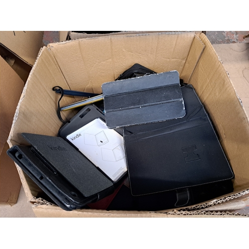 767 - Two boxes, one containing tablet cases and one containing technology items and damaged tablets to in... 